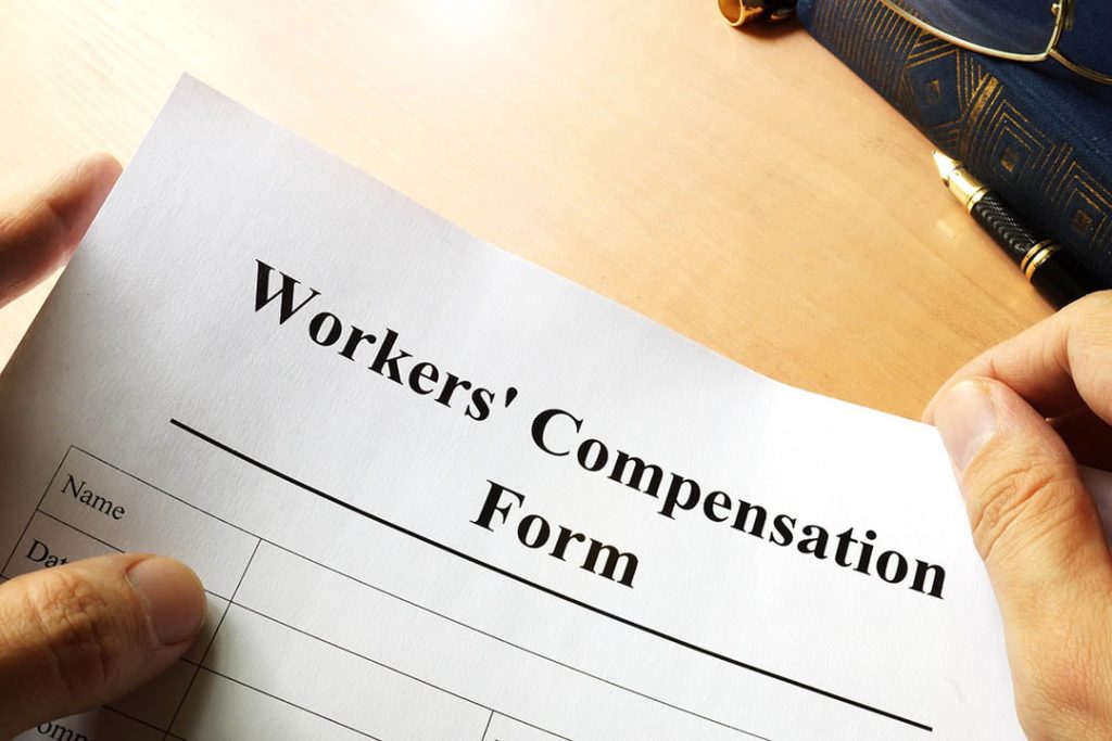 Photo of a workers compensation form on a wood table