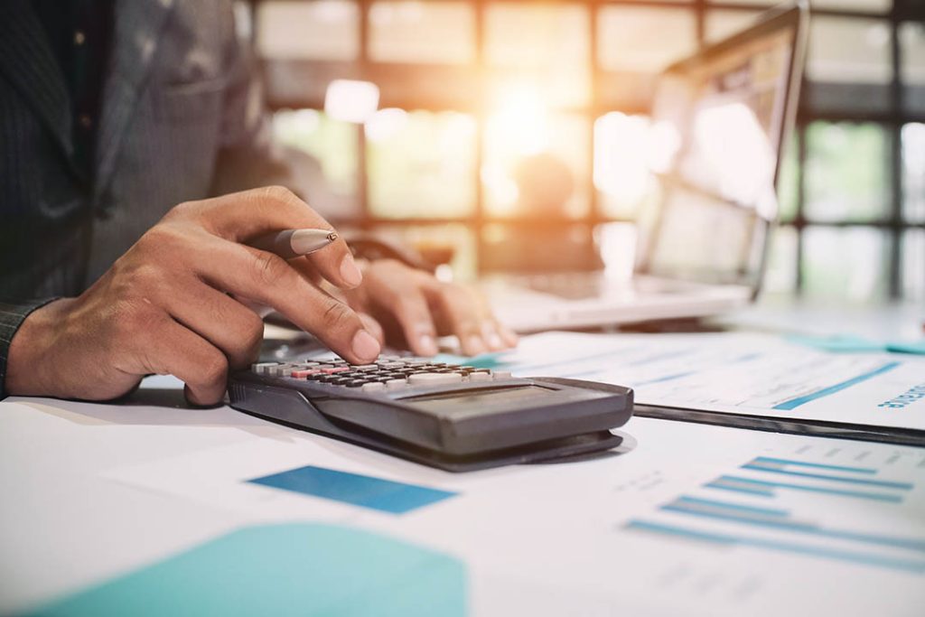 Insurance agent using calculator for medical insurance, the poli