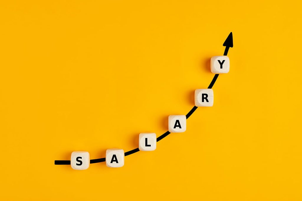 Individual blocks that spell "salary" are arranged on an upward arrow on a yellow background
